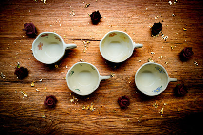 Aesthetic floral ceramic teacup in a pastel pattern, perfect for a cozy reading and tea afternoon.