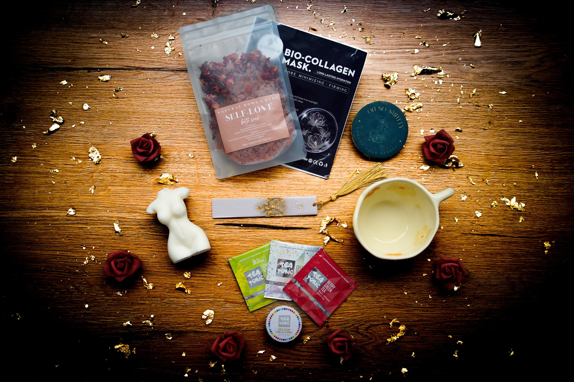 Small Pleasures self-care gift box featuring a wrapped mystery book, ivory Venus torso candle, and floral ceramic teacup.Close-up of the Candle: